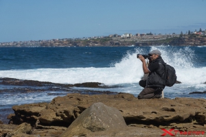 Photographer taking a picture to the sea